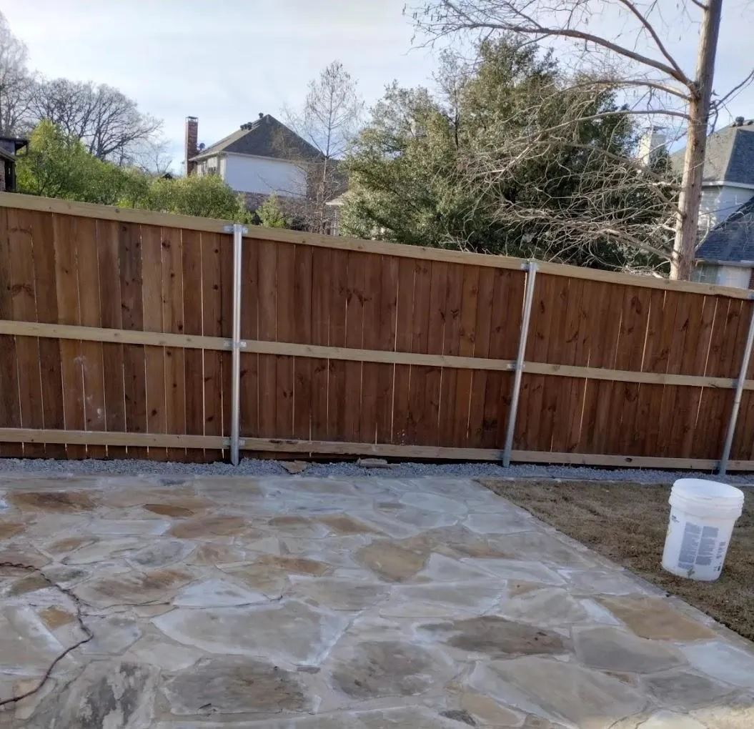 Newly installed wooden fence surrounding a residential backyard in Lewisville, TX