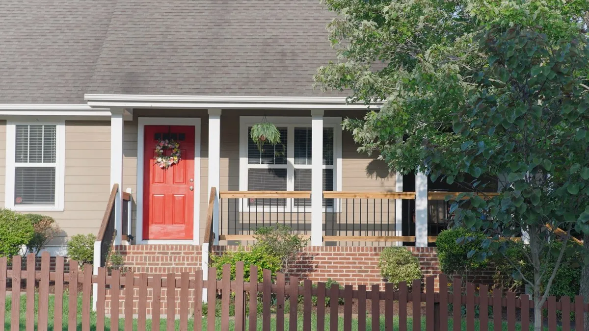 Cottage exterior with a red front door