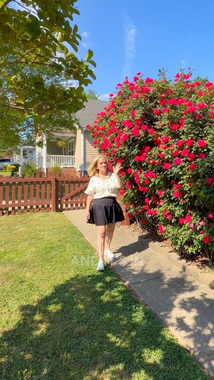 Agent portrait beside flowering roses