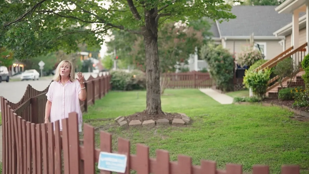 Agent presenting a property outdoors