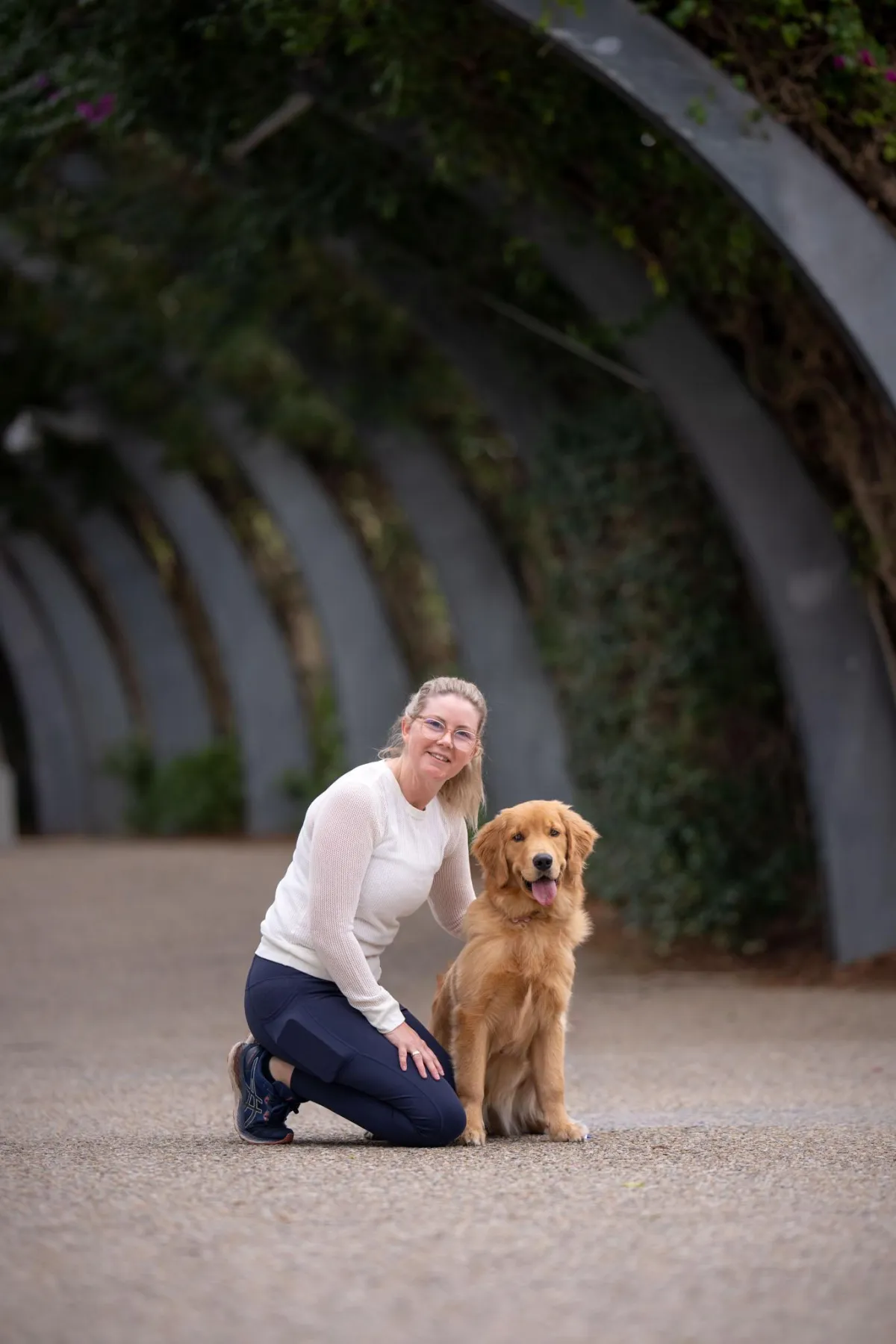Photo of a woman and a golden retriever