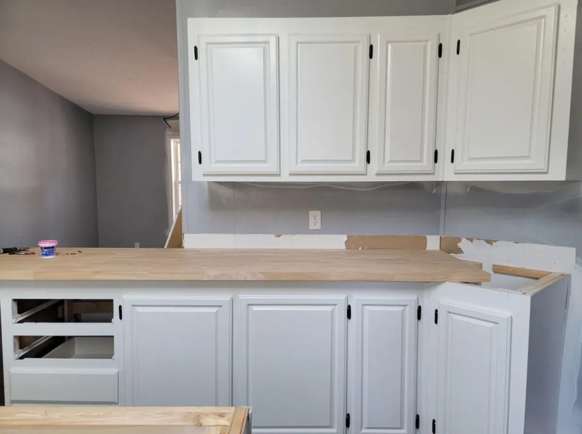 Painting white kitchen cabinets in progress