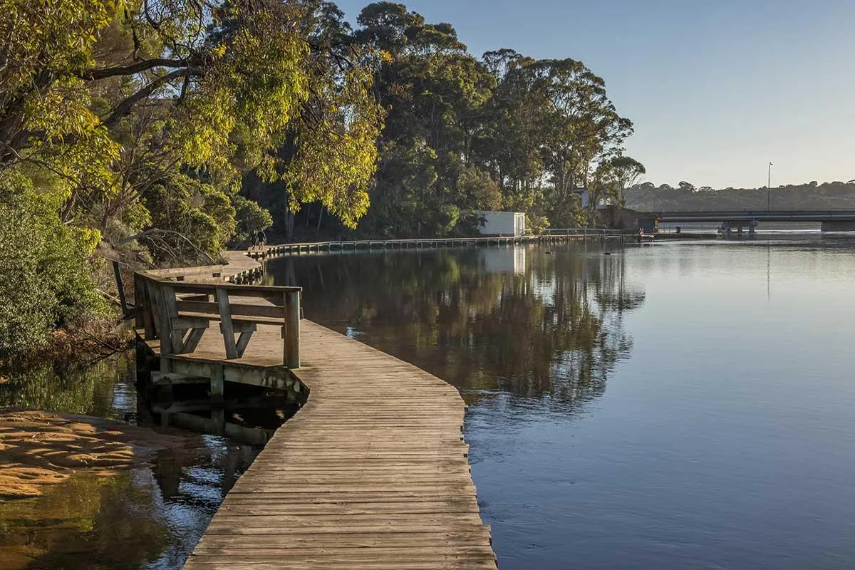 white and brown mountains beside body of water