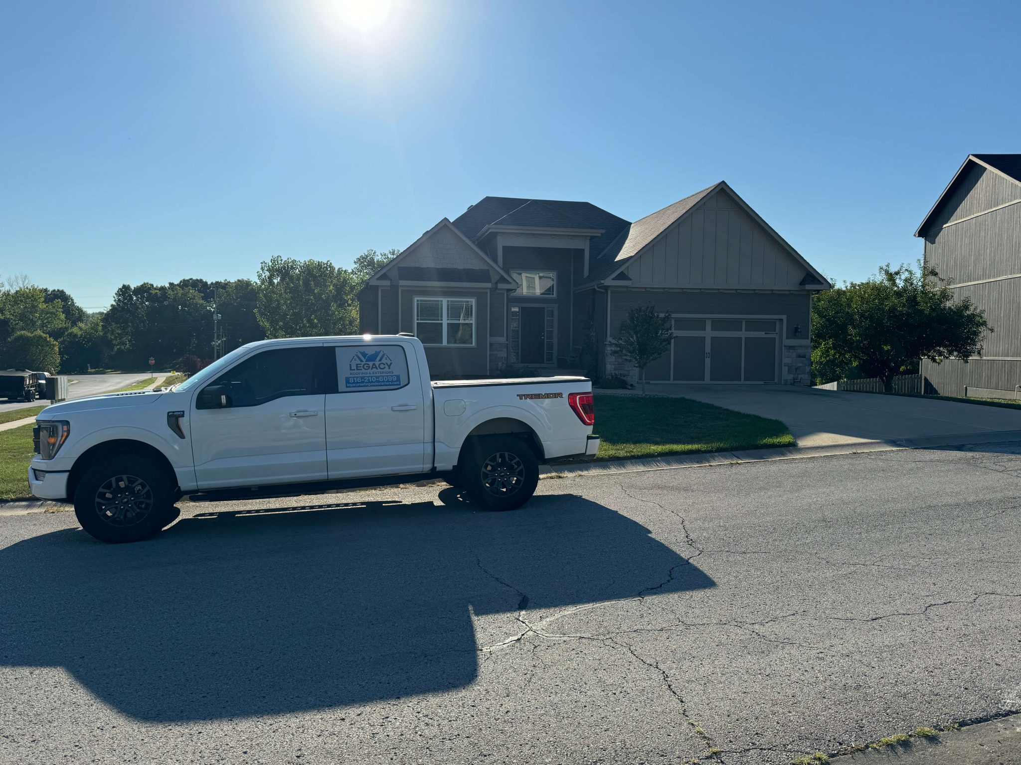Rooftops with a stylish spire against a blue sky.