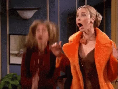 Animated GIF of two women from the TV show Friends, excitedly jumping and cheering with surprised, joyful expressionsâused to convey celebration, enthusiasm, or happy surprise.
