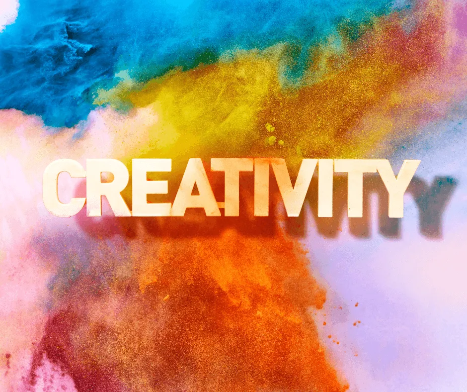 The word CREATIVITY on a background of paints spreading in water