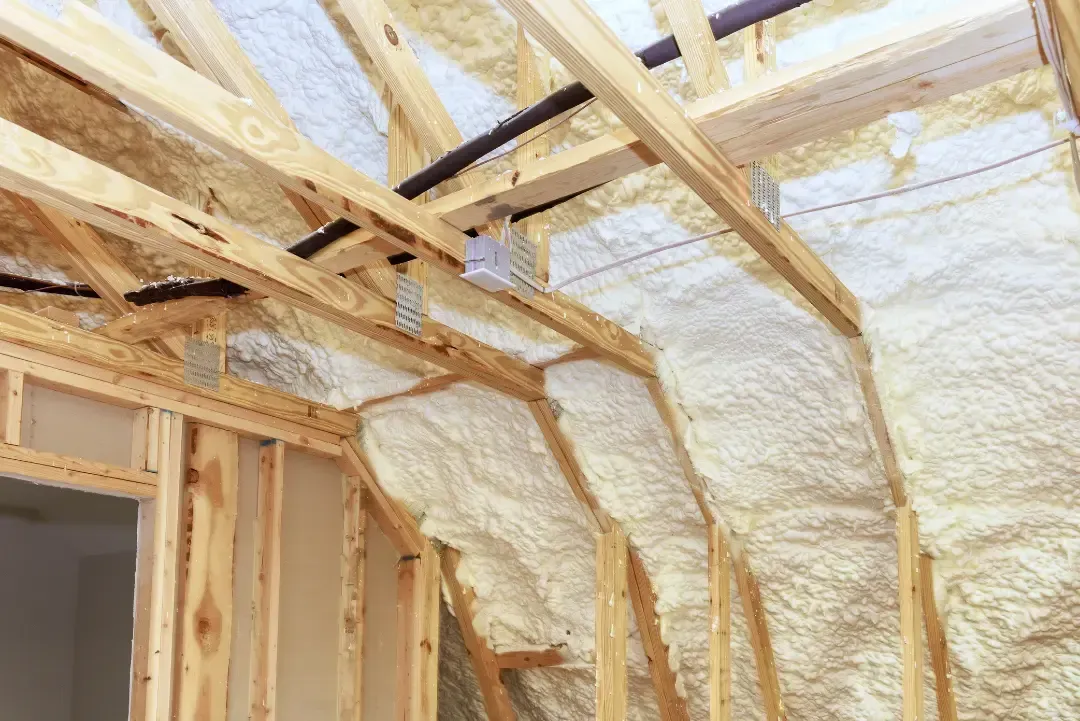 Blown-in insulation layered in attic joists to create a thermal barrier in a home in Astor, Florida