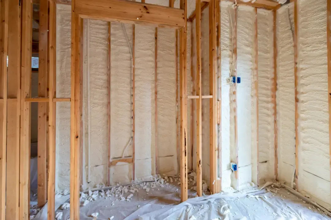 Settled blown-in insulation in ceiling cavities showing maintained thickness in Astor, Florida home