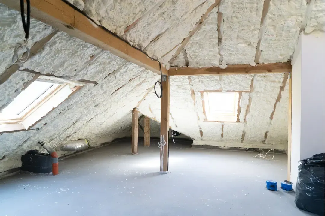 Blown-in insulation being applied to attic floor to improve energy efficiency in Astor, Florida residence