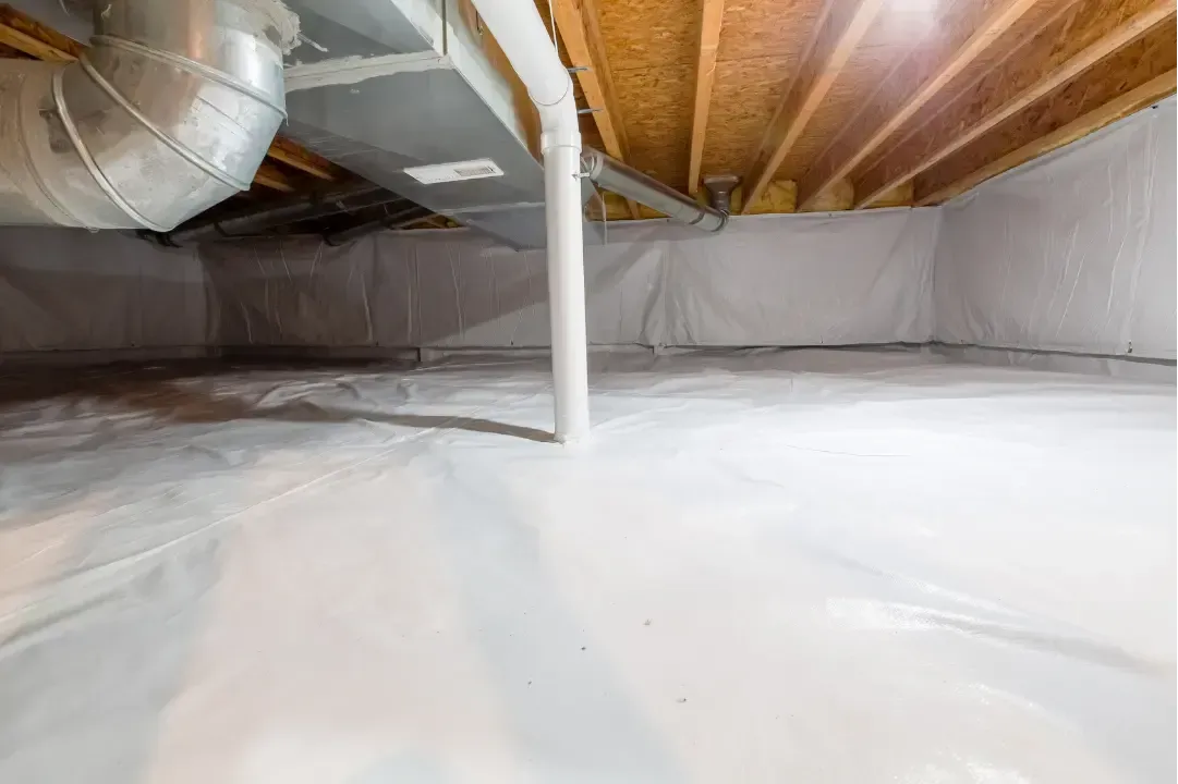Settled blown-in insulation in ceiling cavities showing maintained thickness in Astor, Florida home