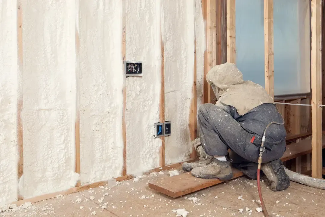 Blown-in insulation being applied to attic floor to improve energy efficiency in Astor, Florida residence