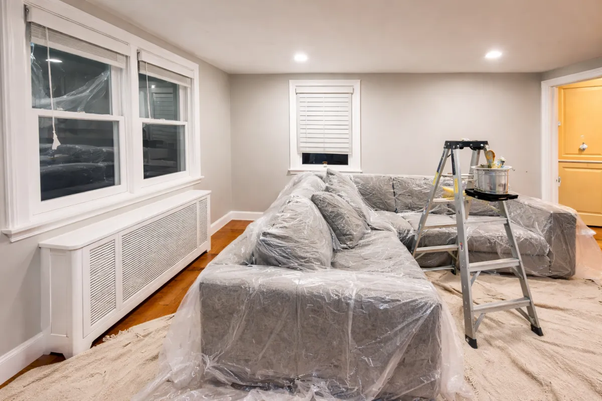 Interior painting service showing protected furniture and freshly painted walls in a Waltham, MA home