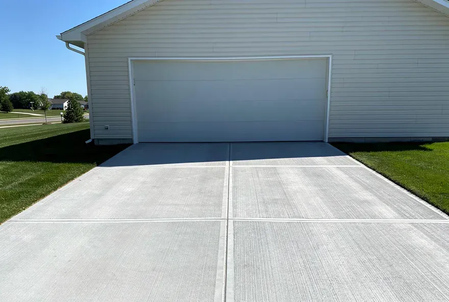 Finished concrete driveway attached to garage of a home in Sheboygan, Wisconsin.