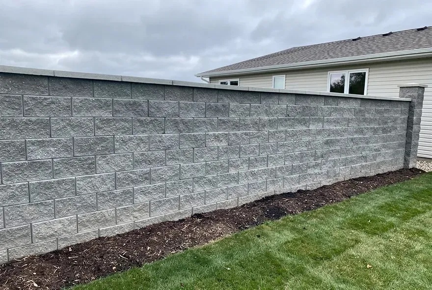 Finished concrete block retaining wall in a backyard in Sheboygan, Wisconsin.