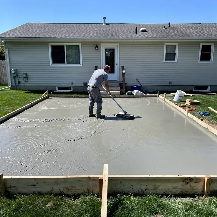 Concrete patio pour in progress at a residential backyard job site in Sheboygan, Wisconsin.