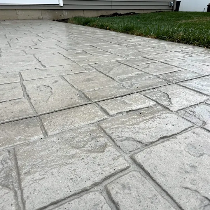 Freshly stamped concrete showing textured pattern before coloring at a job site in Sheboygan, Wisconsin.