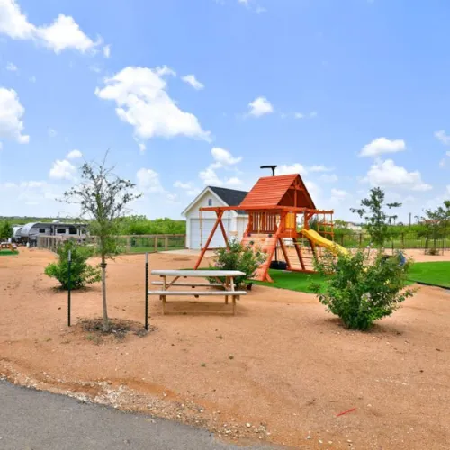 overview of rv resort playground and communal picnic tables