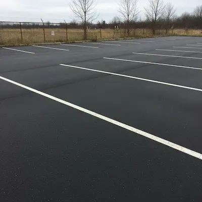 Commercial and multi-unit parking lot paving with proper drainage, layout, and a clean finished surface.