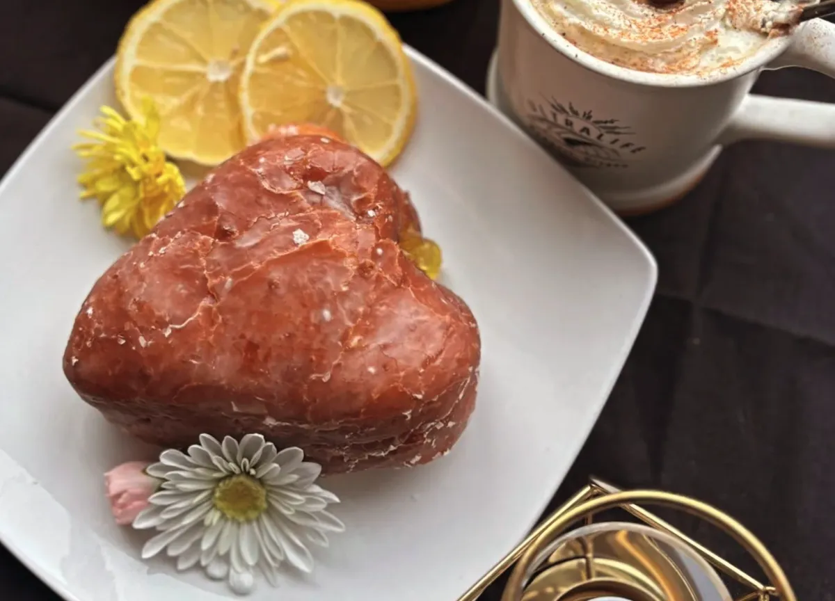 green and white decorative flower on white plate and cutlery set on table