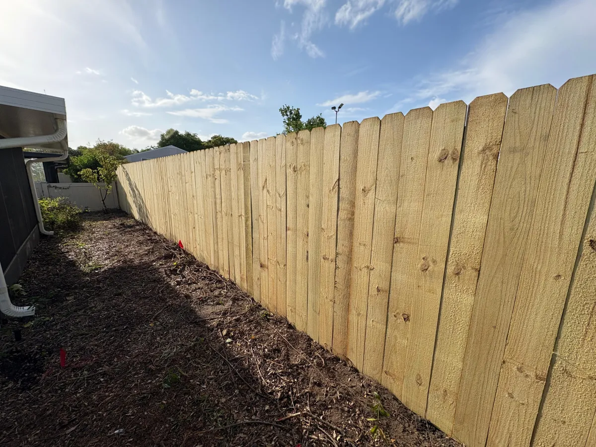 A close up of a metal fence with a blue sky in the background