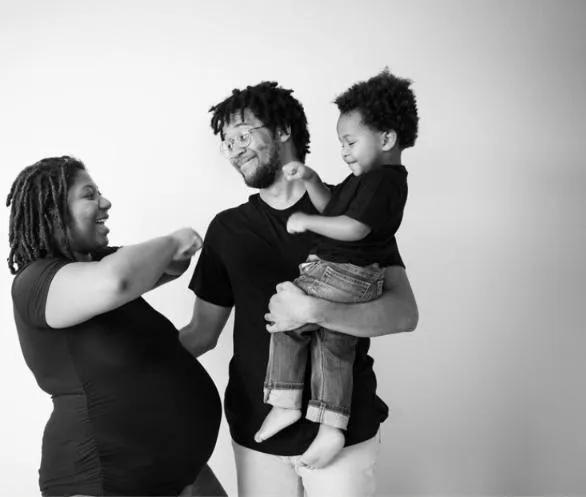 A black and white family portrait showcasing love and connection