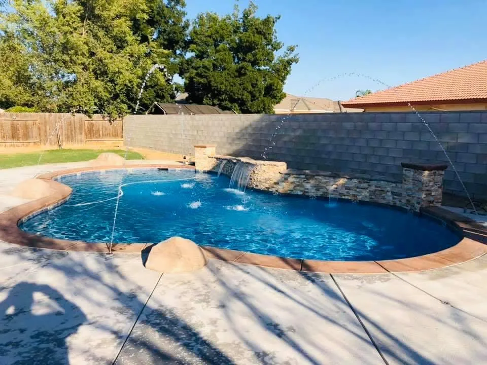 a pool with people in it and a tree with flowers on it