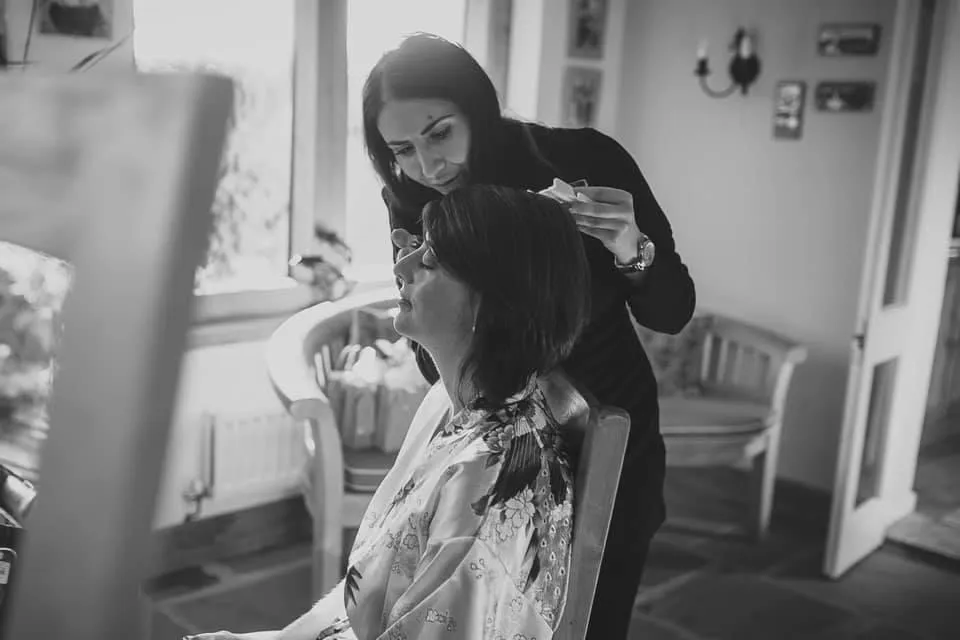 Makeup Artist applying makeup to Bride