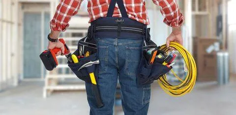 electrician holding wire and drill