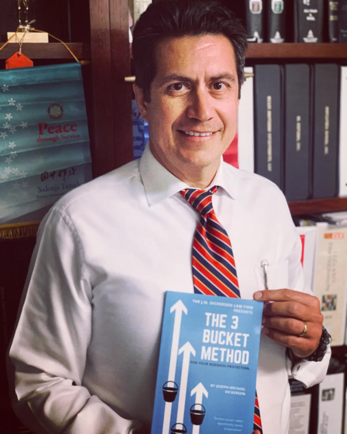 attorney holding free book for proven asset protection method
