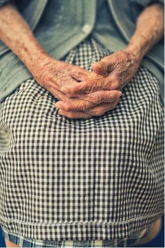 Portrait of an old woman’s frail hands.