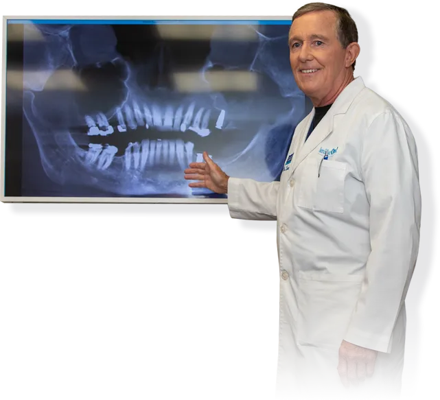 Dr. Lane discussing dental implants and pointing to x-ray