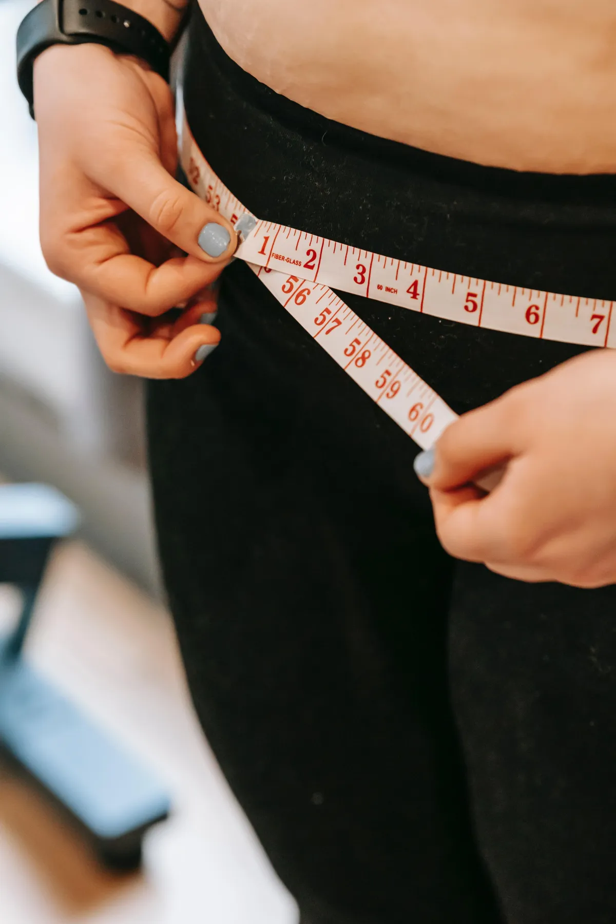 woman with tape measure around her waist