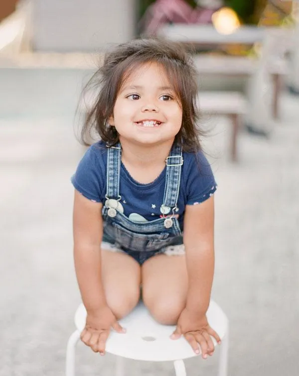 Photo of a Joyful Kid Kneeling Down - Exemplifying the Positive Impact of Parental Tutoring and Homeschooling Coaching