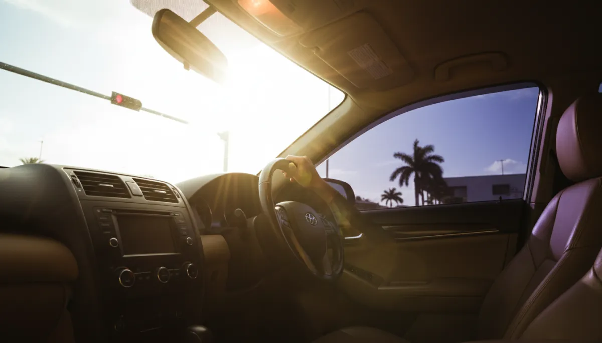 Contrasting hot and cool car interiors at a Miami stoplight