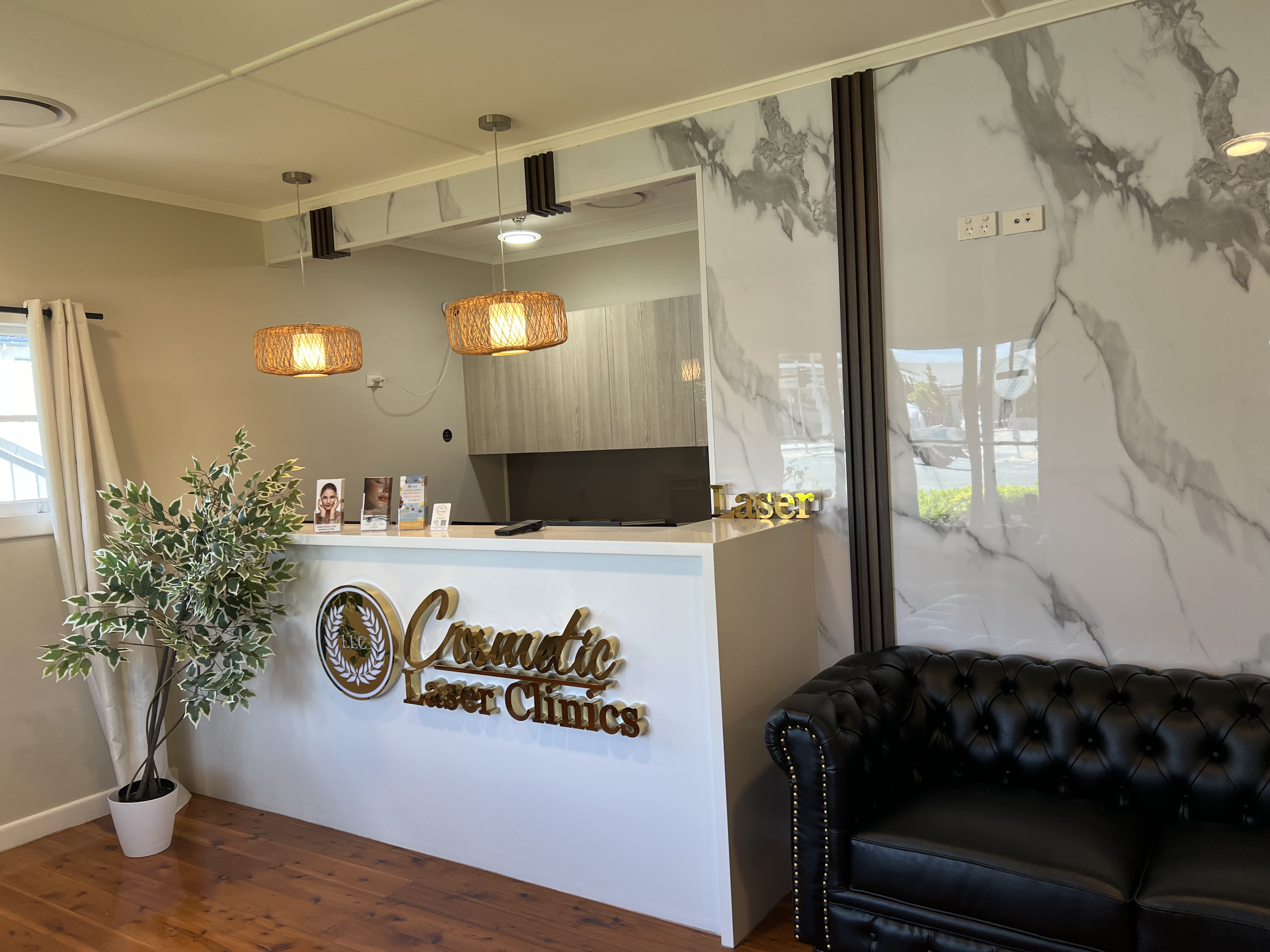 Clinician and client discussing a laser treatment plan in a consultation room