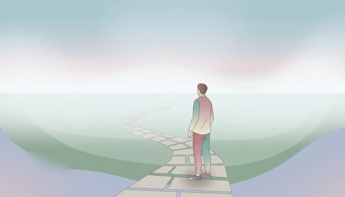 Person standing at the beginning of a foggy path, symbolizing moving forward despite uncertainty