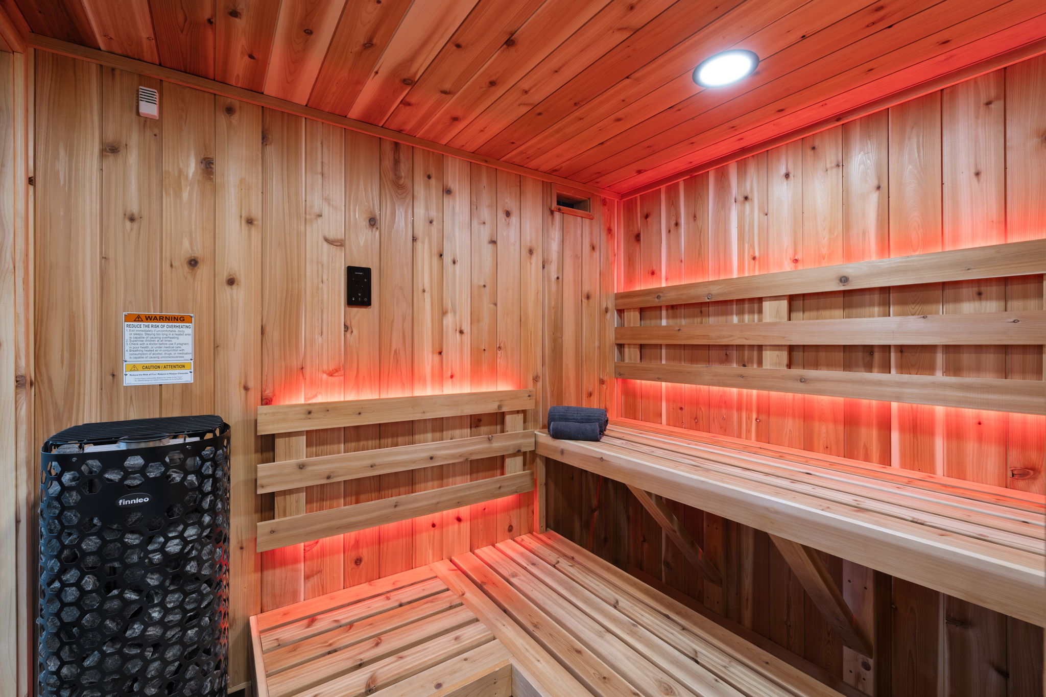 Interior view of sauna with warm lighting and wood benches