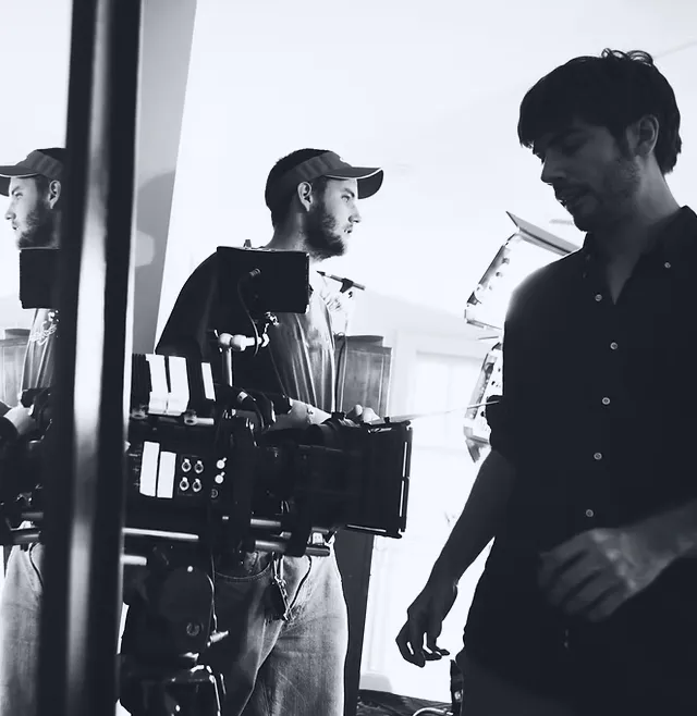 Production crew working on set with a professional camera rig