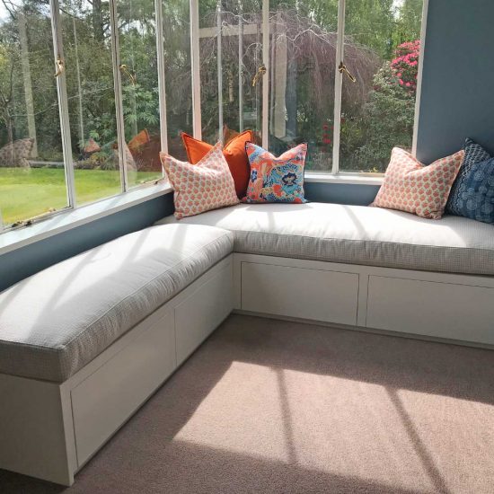 Built-in window seat with white cabinetry and storage drawers (residential joinery detail)