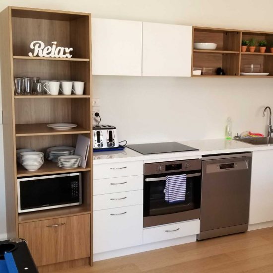 Compact white-and-timber kitchen cabinetry (residential joinery)