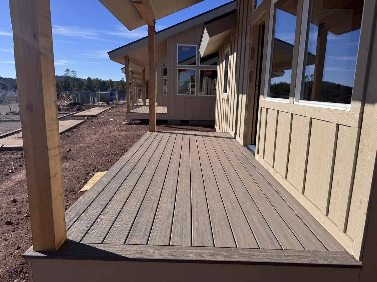 Tiny home exterior progress with porch/deck and windows, Flagstaff, Arizona
