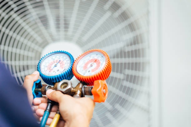 PrimeAir technician inspecting refrigerant pressures.