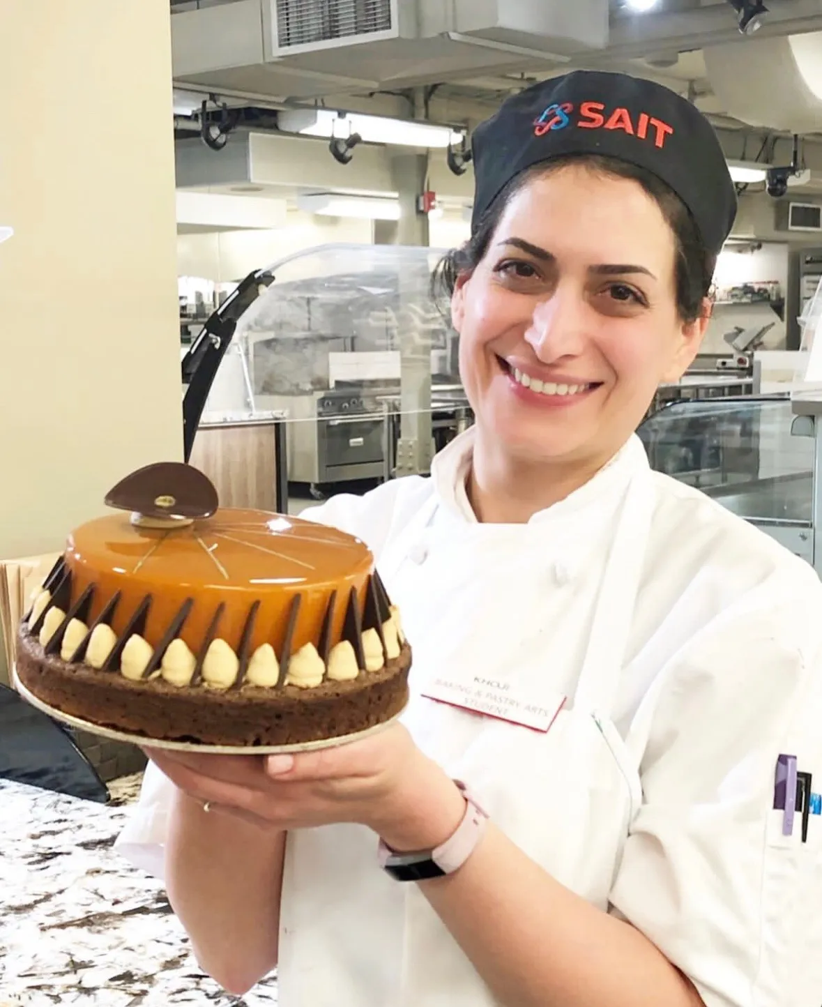 Master baker meticulously finishing artisanal mille-feuille in our Kensington kitchen