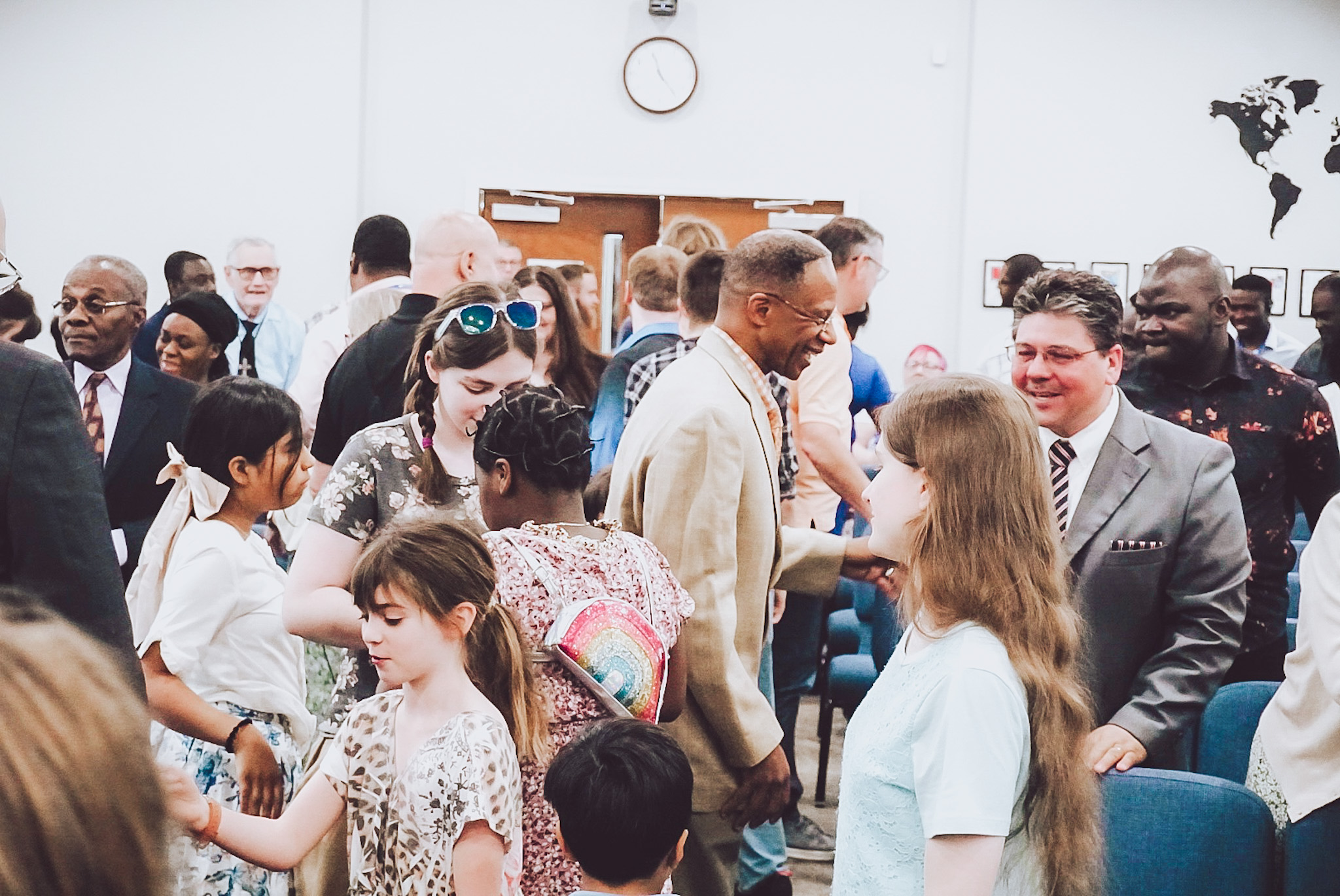 Warm and welcoming church foyer with natural light and friendly greeters