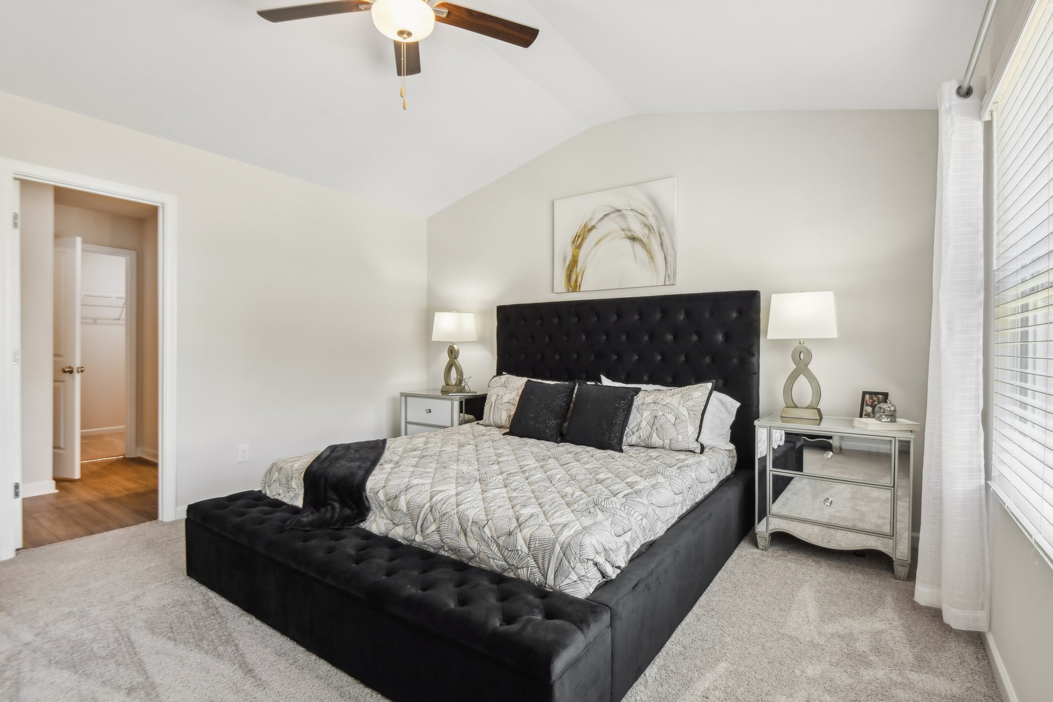 Elegant two-story custom modern farmhouse with black trim and pristine landscaping