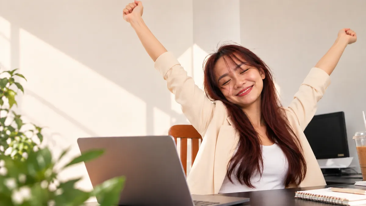 TaskTelle virtual assistant stretching with arms raised in a sunlit workspace