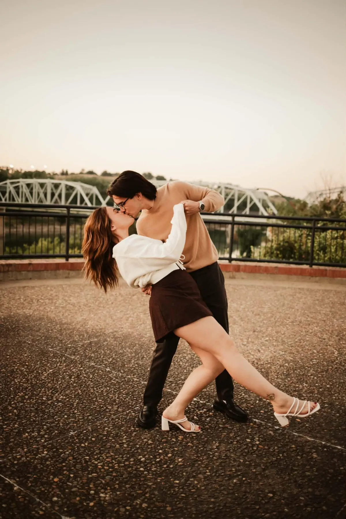 A happy couple laughing together on the softly lit dance floor during date night