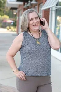 Kristen on the phone while standing outside.
