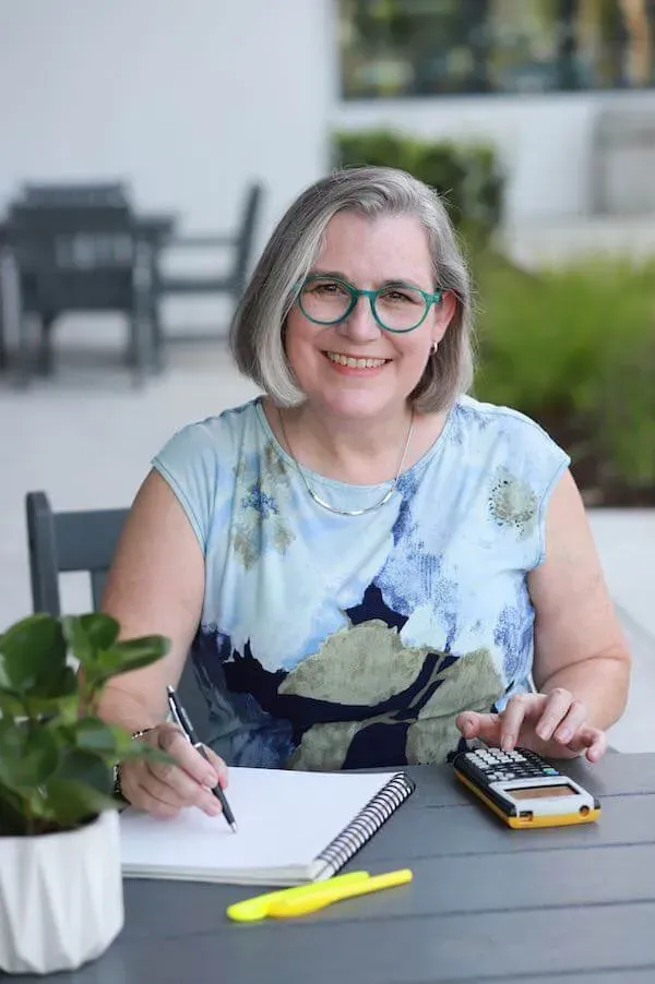 Kristen West McGuire sitting at desk writing
