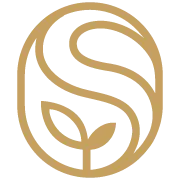 A gold and black emblem with a stylized tree and leaf design